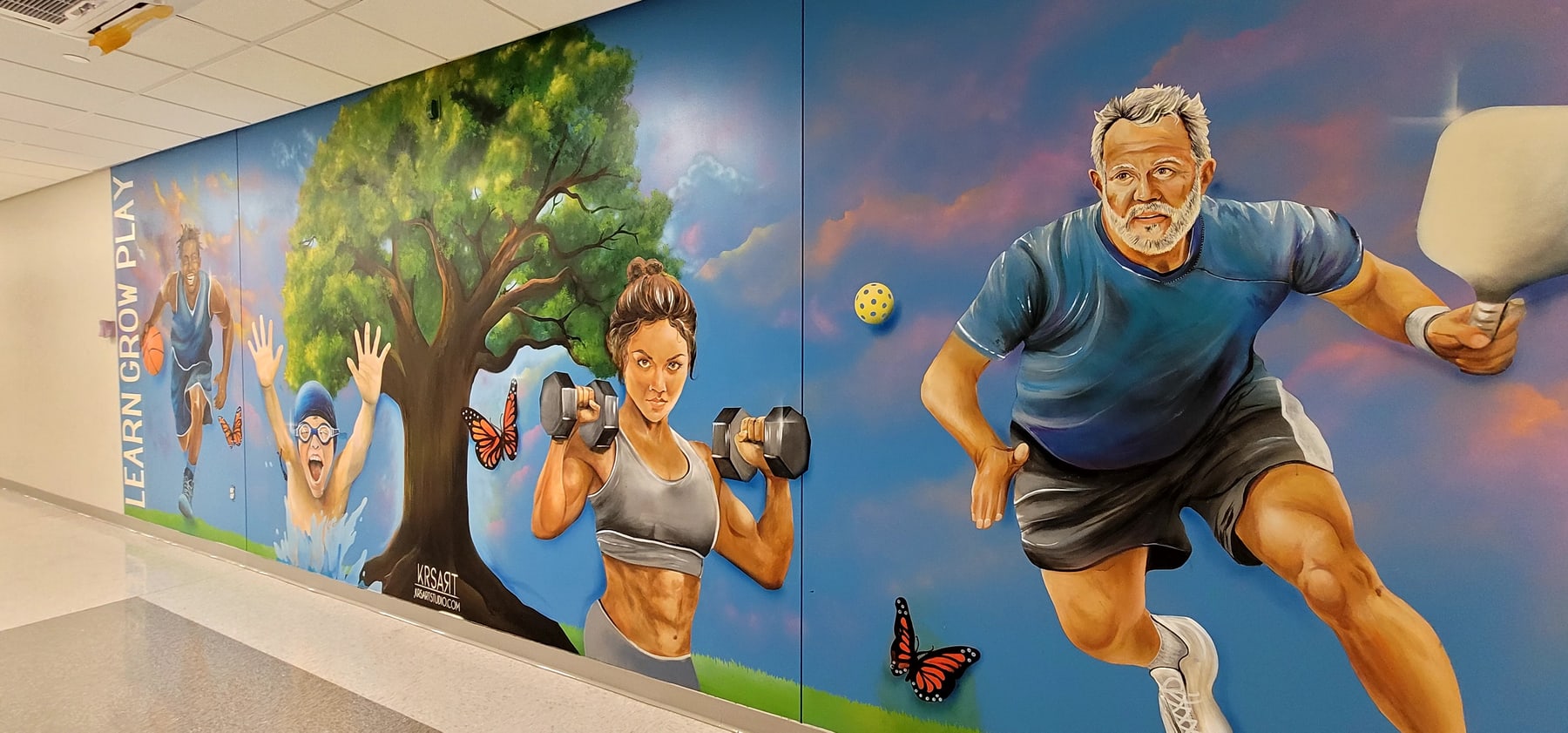 Finished Parks and Recreation Center mural featuring athletes, fitness, and community recreation